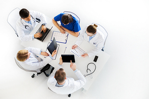 medicine, healthcare and people concept - group of doctors with x-ray, cardiogram, laptop and tablet pc computers on conference at hospital