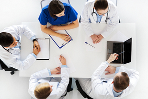 medicine, healthcare and people concept - group of doctors discussing medical report on conference at hospital
