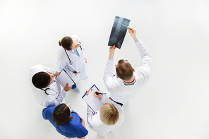 medicine, healthcare and surgery concept - group of doctors or surgeons with spine x-ray and clipboards at hospital