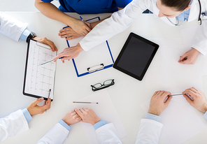 medicine, healthcare and cardiology concept - group of doctors with cardiogram, clipboard and tablet pc computer at hospital