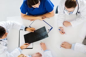 medicine, healthcare and surgery concept - group of doctors or surgeons with spine x-ray and clipboards at hospital