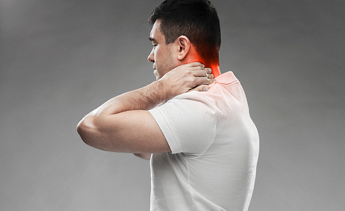 people, healthcare and problem concept - close up of man suffering from neck pain over gray background