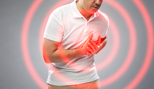 people, healthcare and problem concept - close up of man suffering from heart ache over gray background