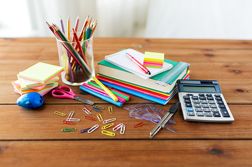 education, school supplies, art, creativity and object concept - close up of stationery on wooden table