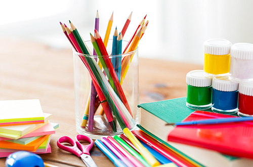 education, school supplies, art, creativity and object concept - close up of stationery on wooden table