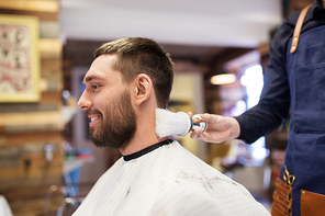 grooming, hairdressing and people concept - man and barber cleaning neck with brush at barbershop