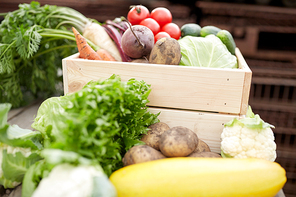 harvest, food nd agriculture concept - close up of vegetables on farm