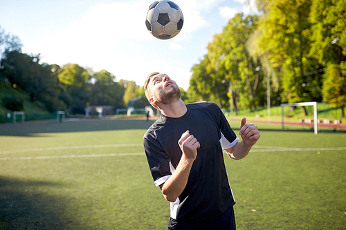 sport, football and people - soccer player playing and juggling ball using header technique on field