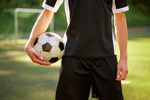 sport, football training and people concept - close up of soccer player with ball on field