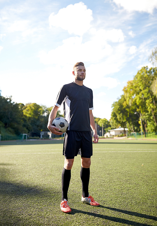 sport, football training and people - soccer player with ball on field