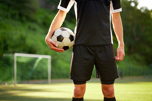 sport, football training and people concept - close up of soccer player with ball on field