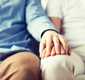 people, homosexuality, same-sex marriage, gay and love concept - close up of happy male gay couple holding hands