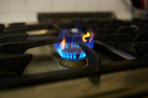 kitchen and cooking concept - burning gas stove flame