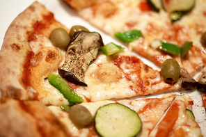 fast food, italian cuisine, cooking and eating concept - close up of pizza