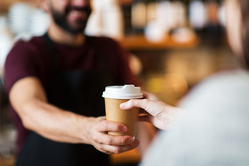 small business, people and service concept - man or bartender serving customer at coffee shop