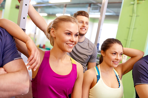 fitness, sport, exercising and healthy lifestyle concept - group of happy people in gym
