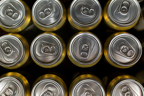 sale and alcohol concept - close up of cans with drinks from top