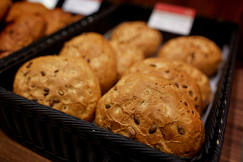 food, baking and sale concept - close up of bread at bakery or grocery store
