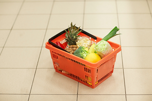 sale, shopping and consumerism concept - food basket on grocery or supermarket floor