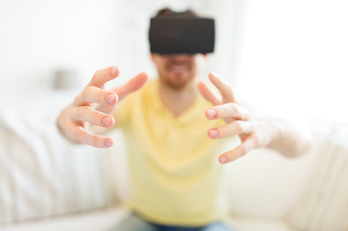 3d technology, virtual reality, gaming, entertainment and people concept - close up of young man with virtual reality headset or 3d glasses playing videogame at home