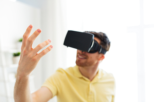 3d technology, virtual reality, gaming, entertainment and people concept - close up of young man with virtual reality headset or 3d glasses playing videogame at home