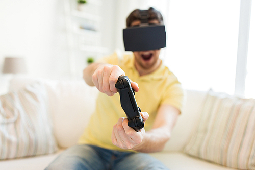 3d technology, virtual reality, gaming, entertainment and people concept - close up of happy young man with virtual reality headset or 3d glasses playing video game with controller gamepad at home