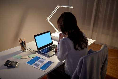 business, people, deadline and technology concept - businesswoman with laptop at night office