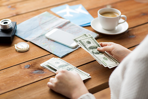 vacation, tourism, travel, finances and people concept - close up of traveler hands counting dollar cash money