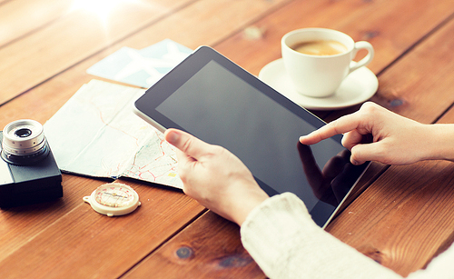 vacation, tourism, travel, technology and people concept - close up of traveler hands with blank tablet pc computer and map