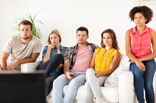 friendship, leisure, junk food, people and entertainment concept - friends watching tv at home