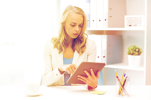 office, business, education, technology and people concept - businesswoman or student with tablet pc computer sitting at table