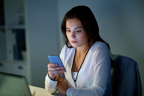 business, corporate, technology and people concept - businesswoman with smartphone at office