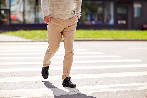 leisure and people concept - senior man walking along summer city crosswalk