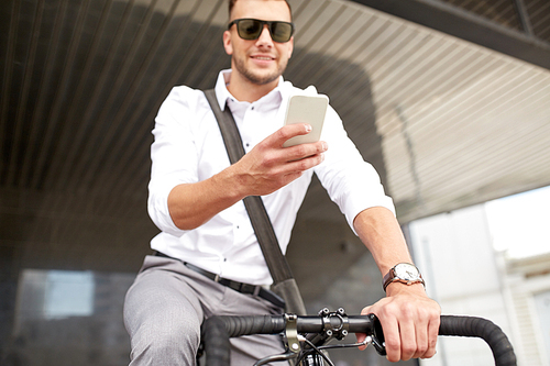 business, people, communication, technology and lifestyle - man texting on smartphone with fixed gear bike on city street