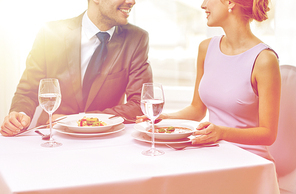 restaurant, food, people, date and holiday concept - close up of happy couple talking at restaurant