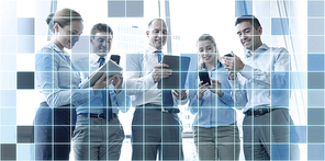 business, teamwork, people and technology concept - business team with tablet pc and smartphones meeting in office over blue squared grid background