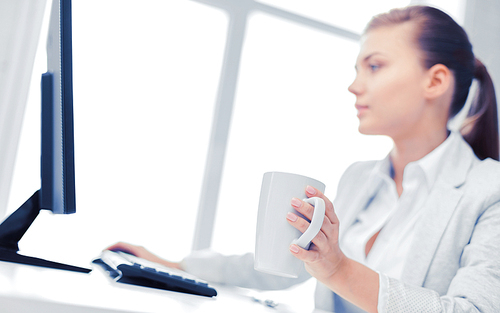 business, office, school and education concept - businesswoman with computer in office drinking coffee