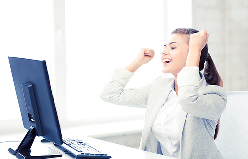 picture of happy businesswoman with computer in office