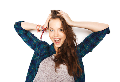 people, hair care, style and teens concept - happy smiling pretty teenage girl touching her head