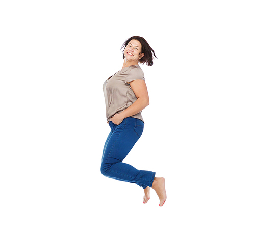 happiness, freedom, motion and people concept - smiling happy plus size woman jumping high in air