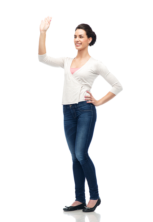 gesture, fashion, portrait and people concept - happy smiling young woman in cardigan cardigan and jeans hand over white