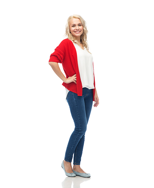 fashion, portrait and people concept - happy smiling young woman in red cardigan and jeans