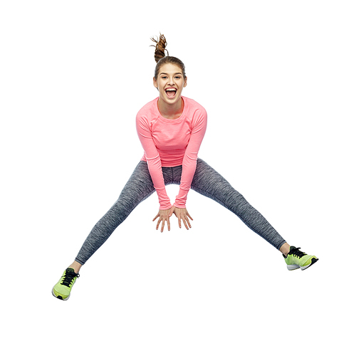 sport, fitness, motion and people concept - happy smiling young woman jumping in air over white background