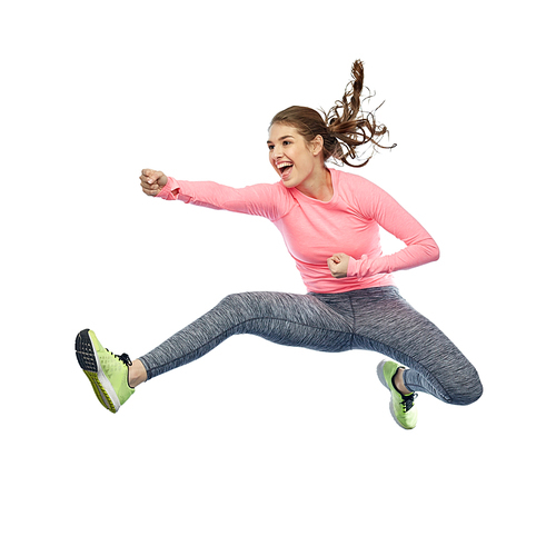 sport, fitness, motion and people concept - happy young woman jumping in air in fighting pose over white background