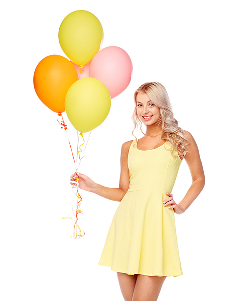 people, holidays and summer party concept - happy young woman or teen girl in pink dress with helium air balloons