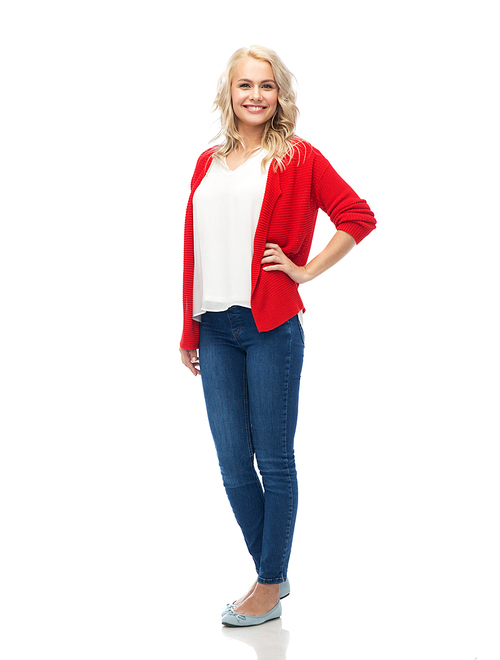 fashion, portrait and people concept - happy smiling young woman in red cardigan and jeans