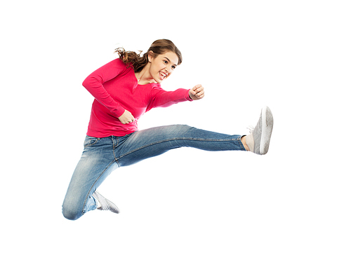 sport, martial arts, motion and people concept - smiling young woman jumping in air and fighting over white background