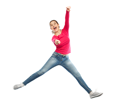 happiness, freedom, motion and people concept - smiling young woman jumping in air and pointing finger to you over white background