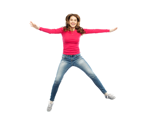 happiness, freedom, motion and people concept - smiling young woman jumping in air over white background