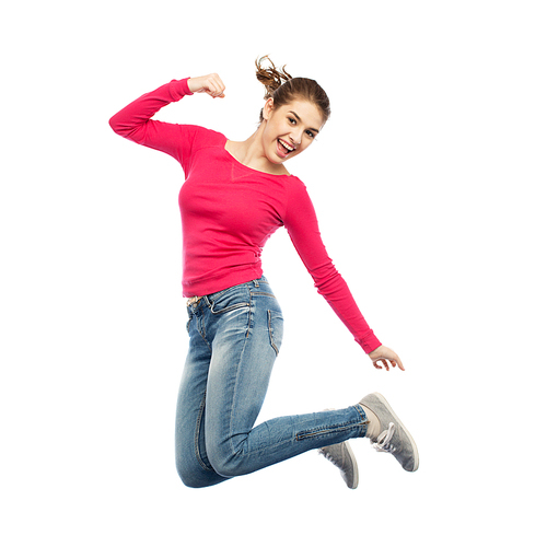 happiness, freedom, power, motion and people concept - smiling young woman jumping in air with raised fists over white background